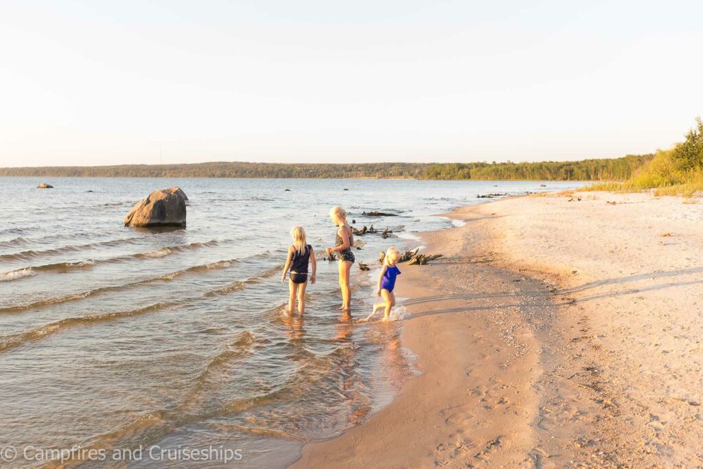 three kids playing on grand beach manitoba